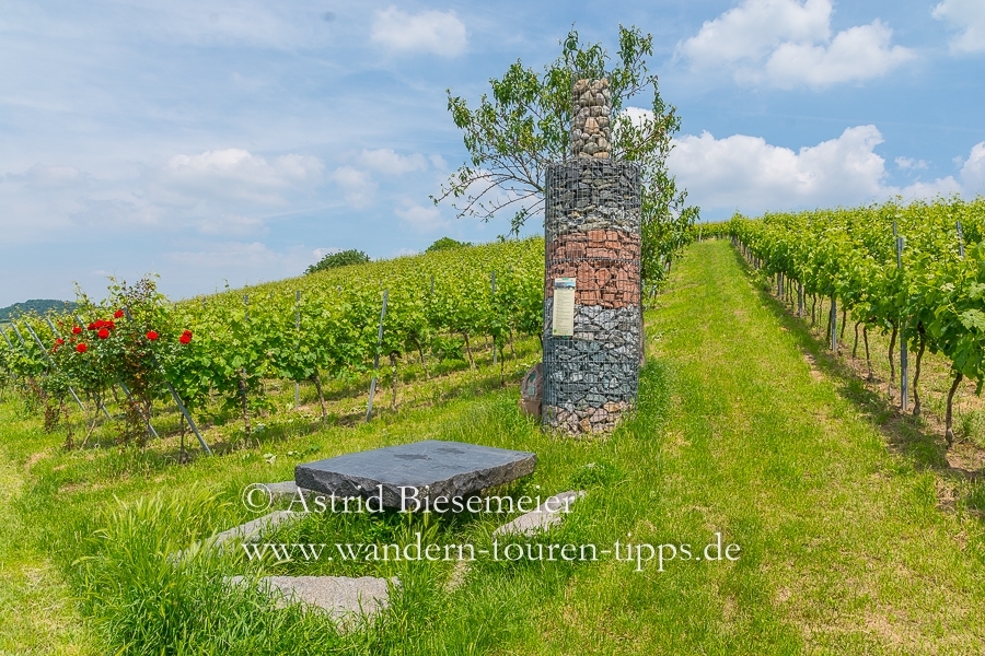Wandern Bergstraße: Rundweg "Wein und Stein" in Heppenheim lädt zur Rast bei einer Flaschen-Skulptur aus Stein ein.